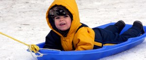 boy on blue sled header