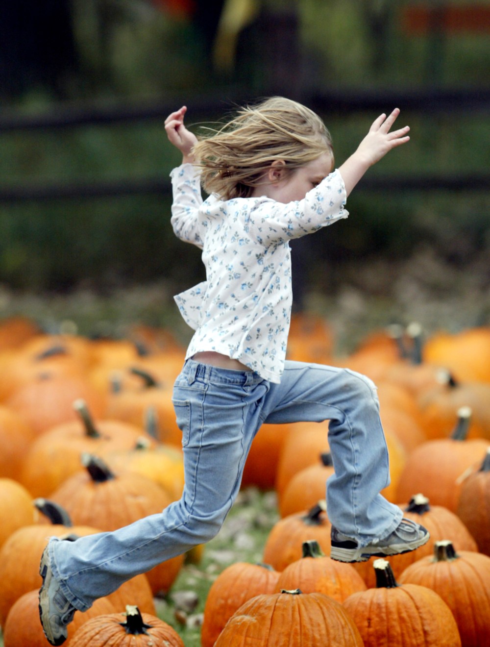 girl jumping pumpkins revised